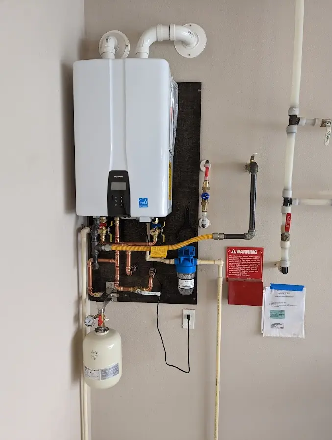 Professional plumber installing copper piping in a Hilliard home